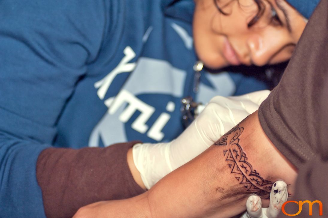 Photo of a Cook Islands tattoo artist applying a traditional tattoo. Taken of Stormy by Amanda Fornal in October 2006.