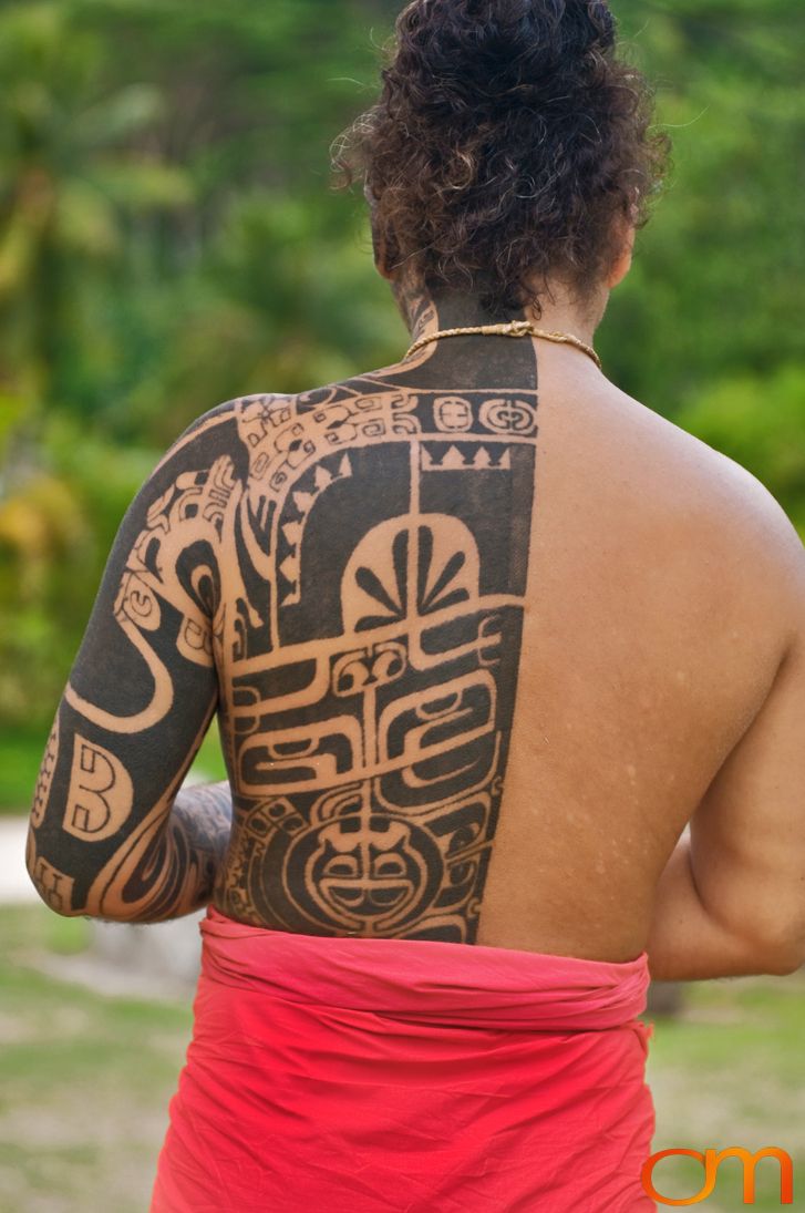 Photo of Polynesian traditional tattoos on a man's back and arm. Taken of Tihoti on the island of Huahine by Amanda Fornal in November 2006.