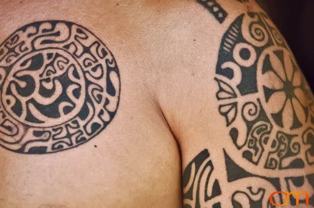 Photo of Polynesian traditional tattoos on a man's chest and shoulder. Taken on the island of Huahine by Amanda Fornal in November 2006.