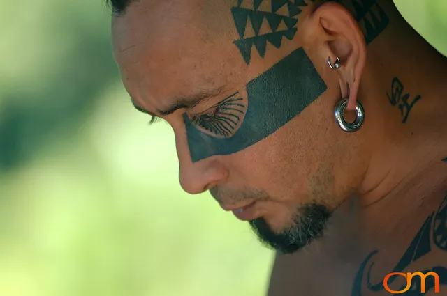 Photo of Polynesian traditional tattoos on a man's face, head, and neck. Taken of Chimi on the island of Mo'orea by Amanda Fornal in October 2006.