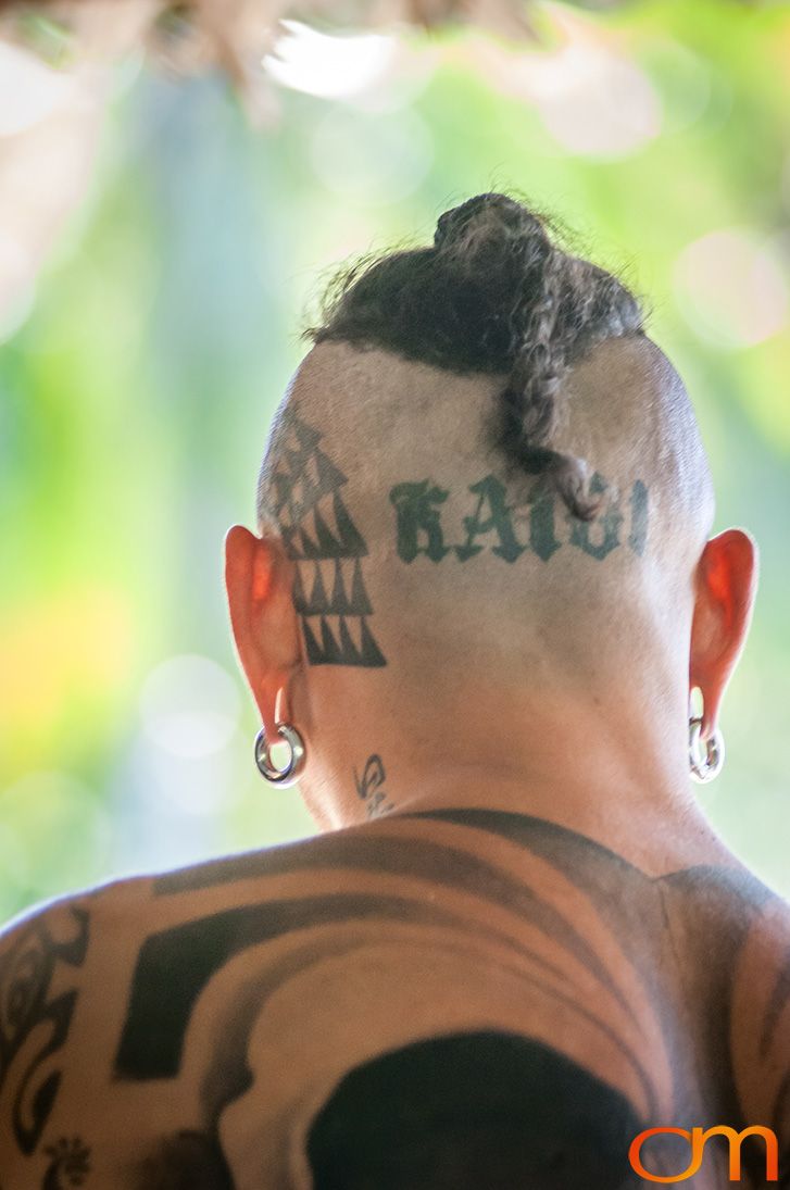 Photo of back of man's head with tattoos on head and back. Taken of Chimi on the island of Mo'orea by Amanda Fornal in October 2006.