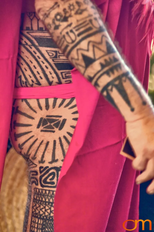 Photo of Polynesian traditional tattoos on a man's arm and leg. Taken at the 2006 Tattoonesia tattoo festival of Raymond Graffe by Amanda Fornal in December 2006.