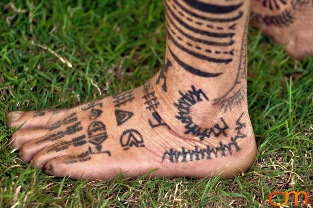 Photo of Polynesian traditional tattoos on a man's foot. Taken at the 2006 Tattoonesia tattoo festival of Raymond Graffe by Amanda Fornal in December 2006.