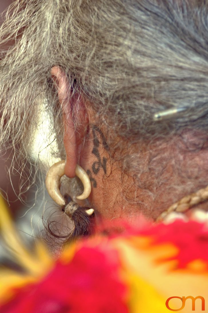 Photo of Polynesian traditional tattoo behind a man's ear. Taken at the 2006 Tattoonesia tattoo festival of Raymond Graffe by Amanda Fornal in December 2006.