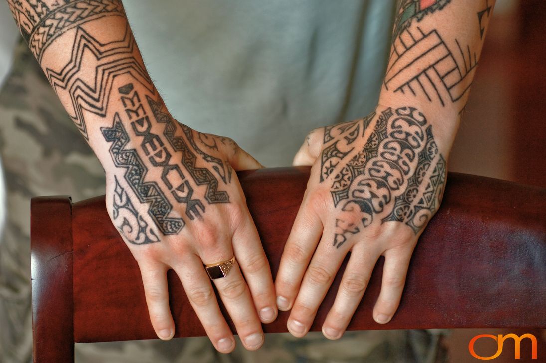 Photo of traditional tattoo designs on a man's arm. Taken of Steven Ball at the 2006 Tattoonesia tattoo festival by Amanda Fornal in December 2006.