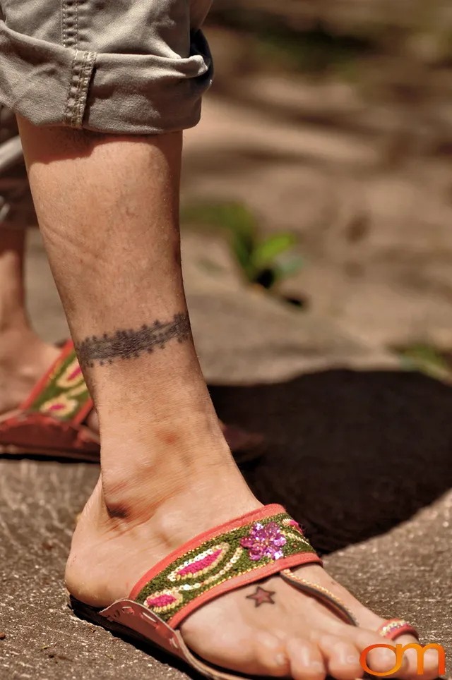 Photo of Polynesian traditional tattoos on a woman's ankle. Taken at the 2006 Tattoonesia tattoo festival by Amanda Fornal in December 2006.