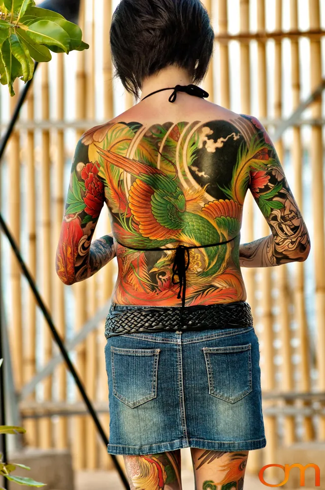 Photo of a Japanese bodysuit tattoo on a woman. Taken at the 2006 Tattoonesia tattoo festival of Yoko by Amanda Fornal in December 2006.