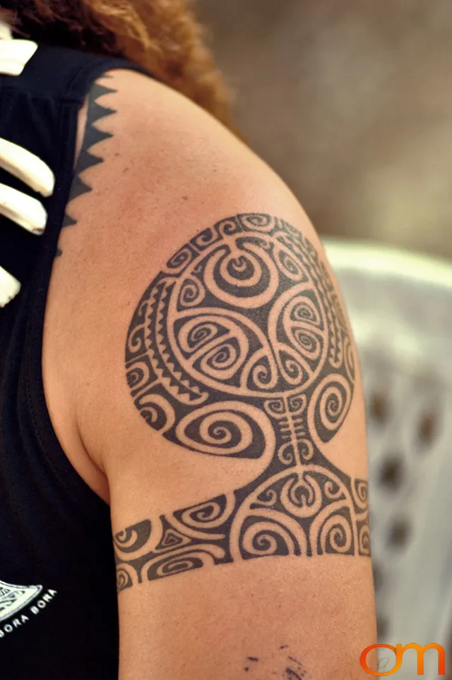 Photo of Polynesian traditional tattoo on a man's arm and shoulder. Taken of Jean Eve on the Marquesas island of Nuku Hiva by Amanda Fornal in October 2006.