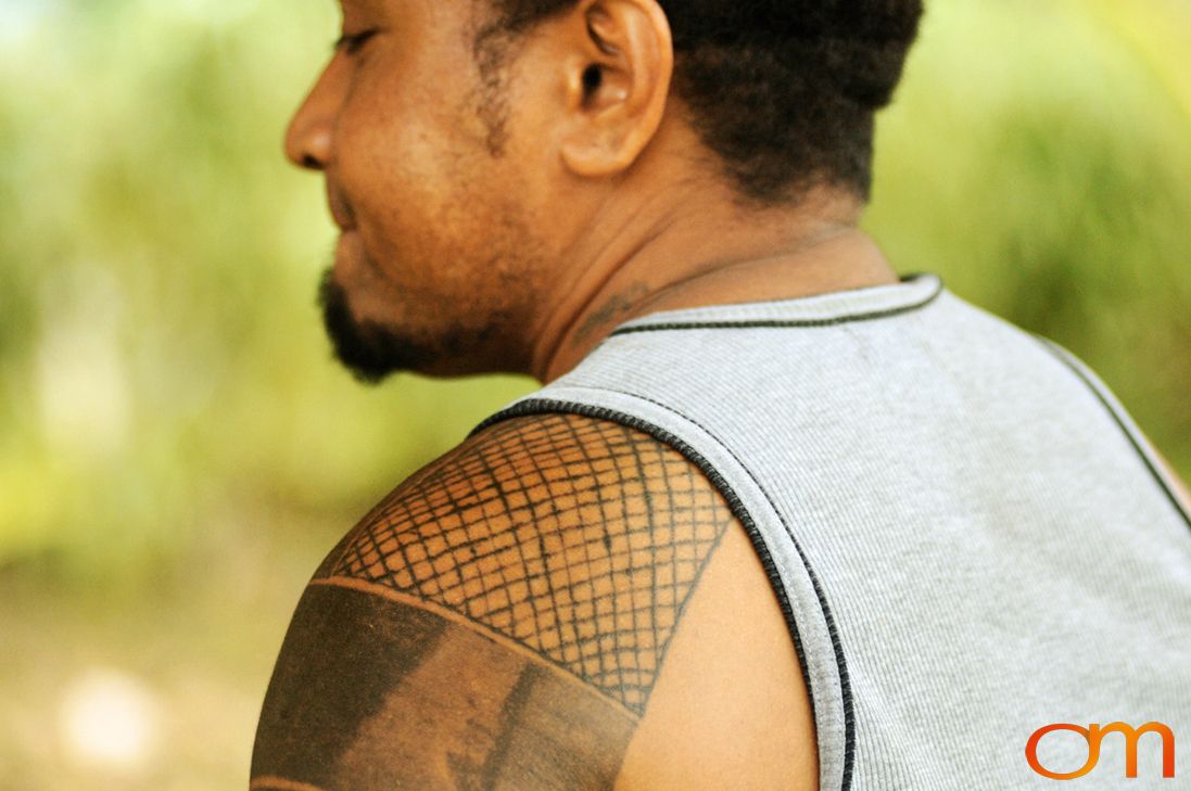 Photo of Solomon Island traditional tattoo on a man's shoulder. Taken of Wes on the island of Rennell by Amanda Fornal in December 2006.