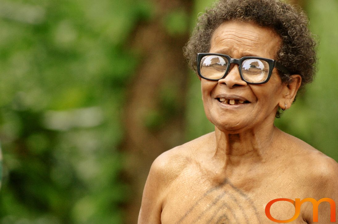 Photo of Vanuatu woman with a traditional tattoo on her chest. Taken of Catherine on the Vanuatu Island of Ambae by Amanda Fornal in December 2006.