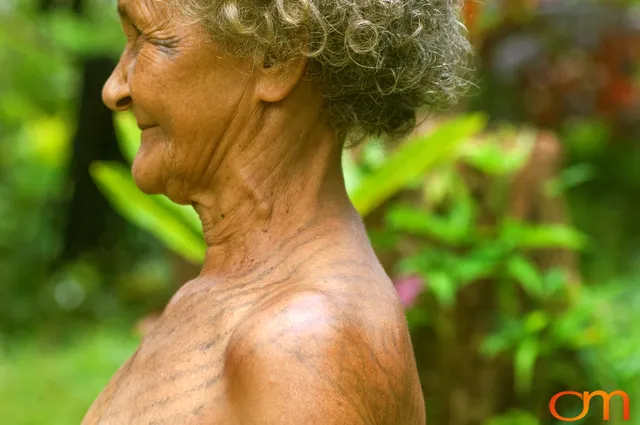 Photo of Vanuatu woman with a traditional tattoo on her face, shoulders, back, and chest. Taken of Julliet on the Vanuatu Island of Ambae by Amanda Fornal in December 2006.