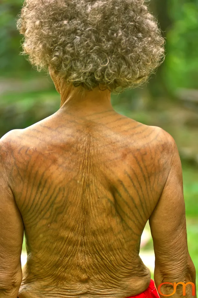 Photo of Vanuatu woman with a traditional tattoo on her shoulders and back. Taken of Julliet on the Vanuatu Island of Ambae by Amanda Fornal in December 2006.