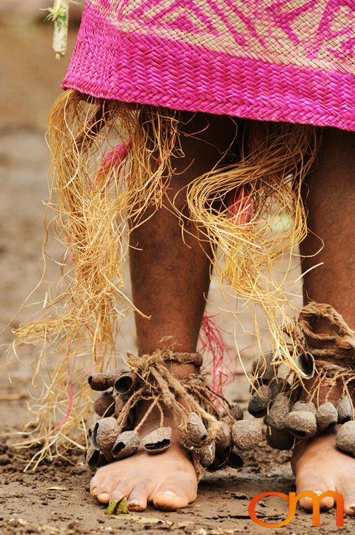 Photo of a Vanuatu woman's legs and feet with a traditional dancing jewelery and matt. Taken of Kenna on the Vanuatu Island of Ambae by Amanda Fornal in December 2006.