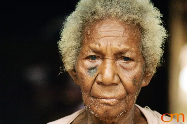 Photo of Vanuatu woman with a traditional tattoo on her face. Taken on the Vanuatu Island of Mota Lava by Amanda Fornal in December 2006.