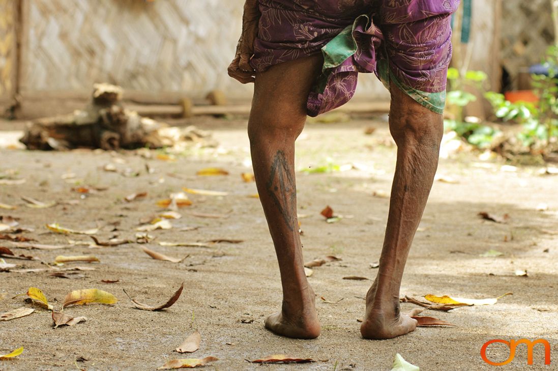 Photo of Vanuatu woman with traditional tattoos on her legs. Taken on the Vanuatu Island of Mota Lava by Amanda Fornal in December 2006.